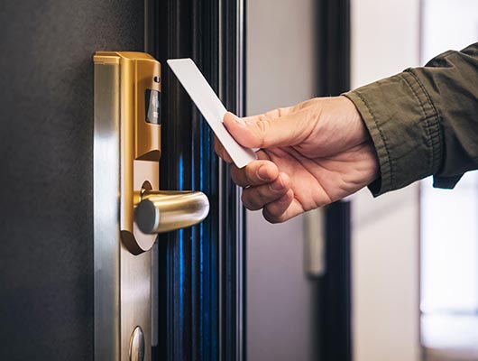 Person using key-card-reader to open door