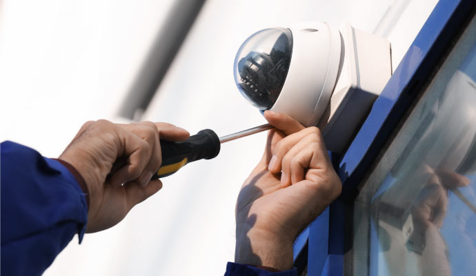 professional worker installing security camera  