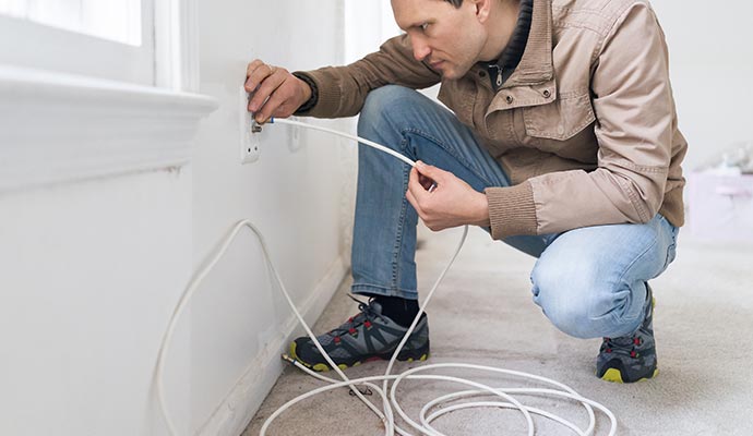 Person installing cable network in a room