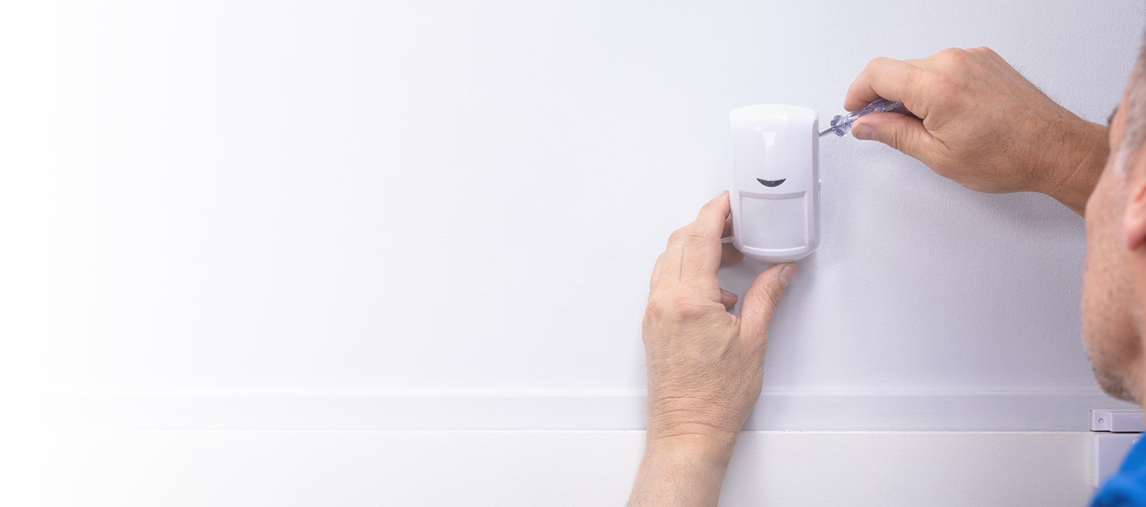 Technician fixing a smoke detector